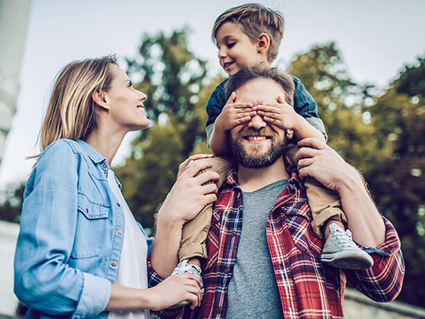 Husband and wife playing with child while travelling