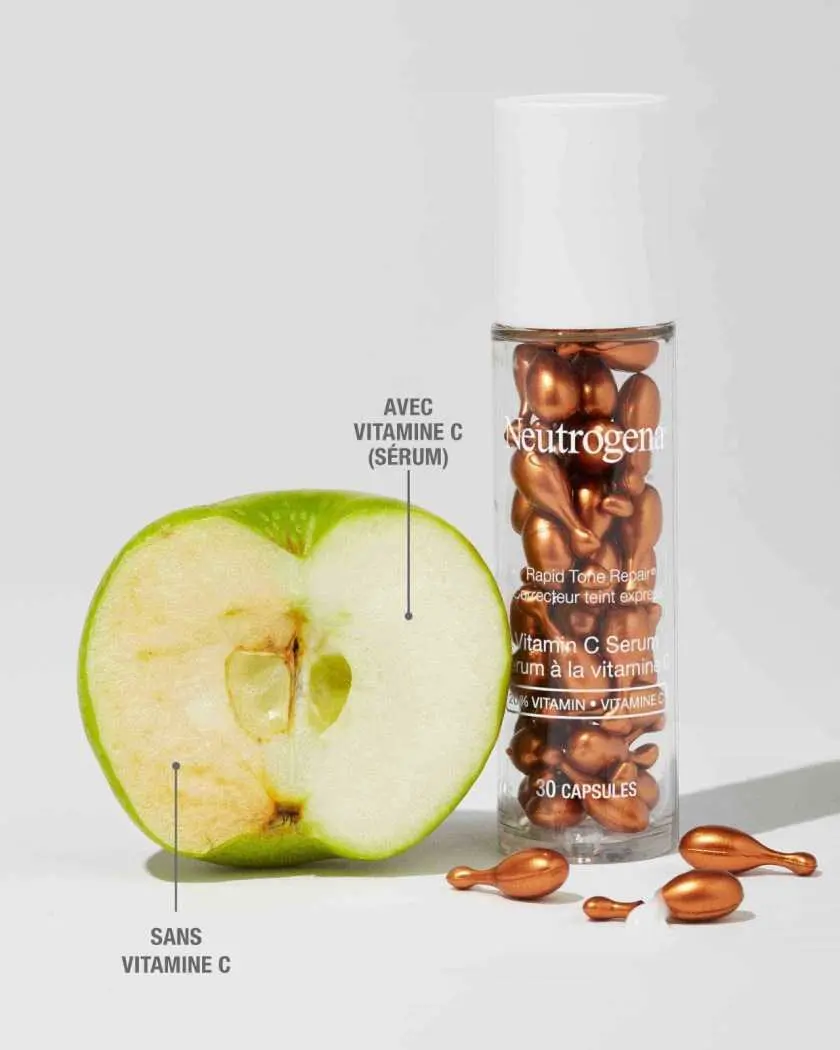 Flacon de 30 unités de sérum NEUTROGENA® Correcteur teint express 20 % de vitamine C en capsules, et démonstration de l'application de sérum de vitamine C sur une pomme