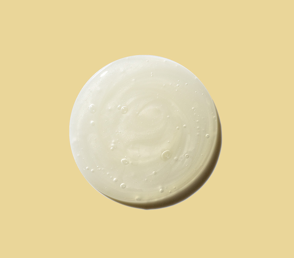 circle drop of lotion against a yellow background