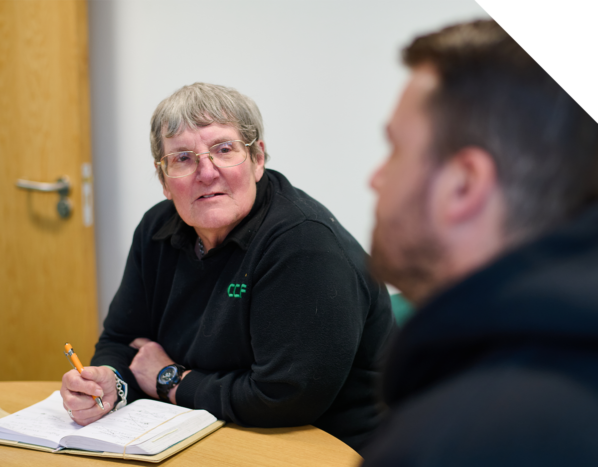 CCF female staff member listening during a meeting.