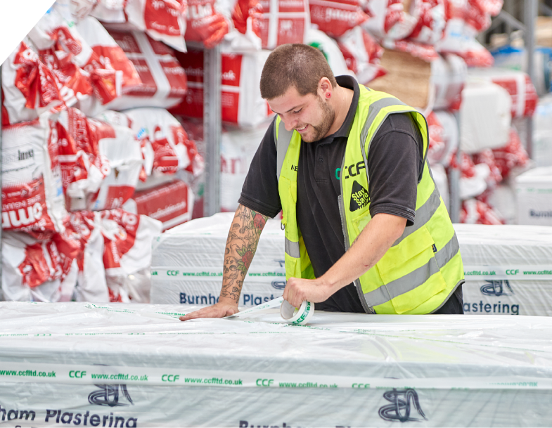 A male CCF employee is taping a plasterboard package