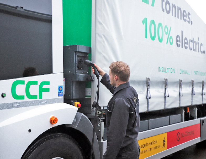 A CCF employee charging an electric lorry