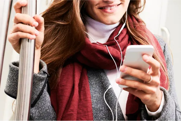 Women listening on headphones on a train