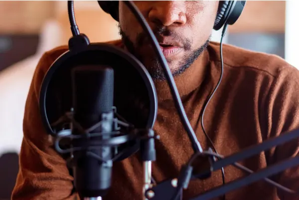 Man siting at a boom microphone talking