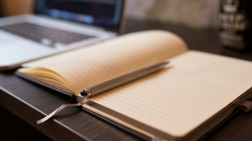 A notepad and pen on a desk