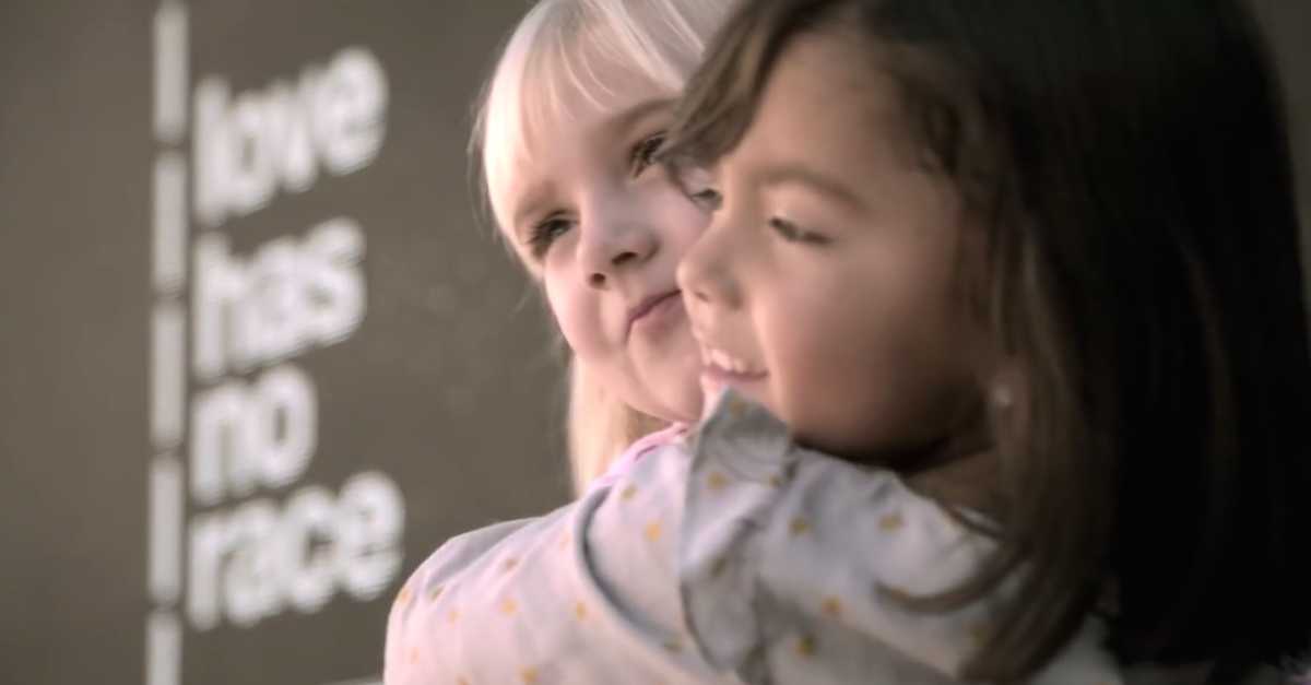Two Little Girls Embrace And Have A Crowd Of Onlookers In ...