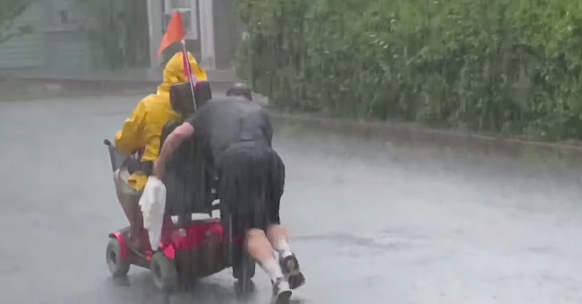 Neighbor Catches Soaked Stranger Pushing A Disabled Man's Wheelchair