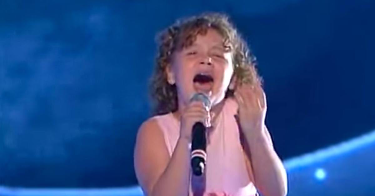 Little Girl Walks On Stage. When She Opens Her Mouth The Crowd Is