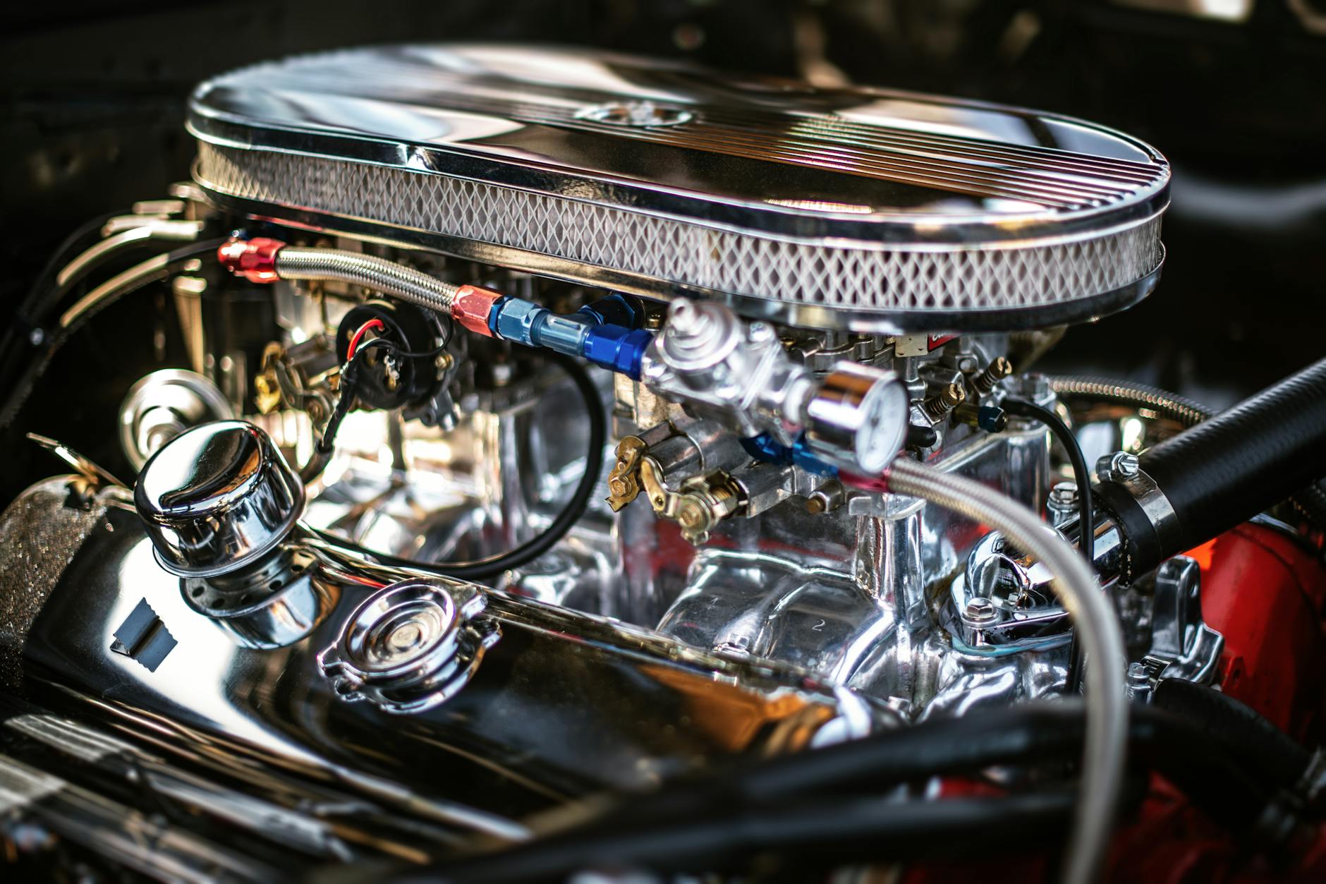 Detailed view of a shiny chrome car engine highlighting automotive technology.