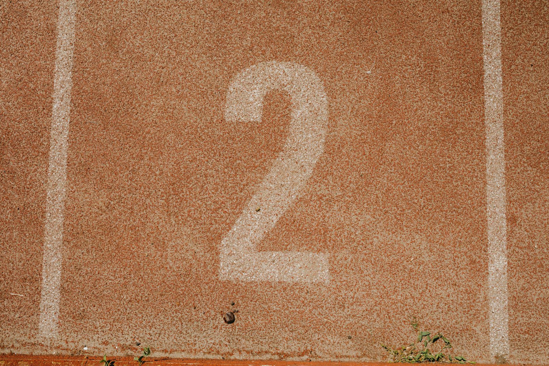 Close-up of number two on a track starting line, perfect for sports themes.