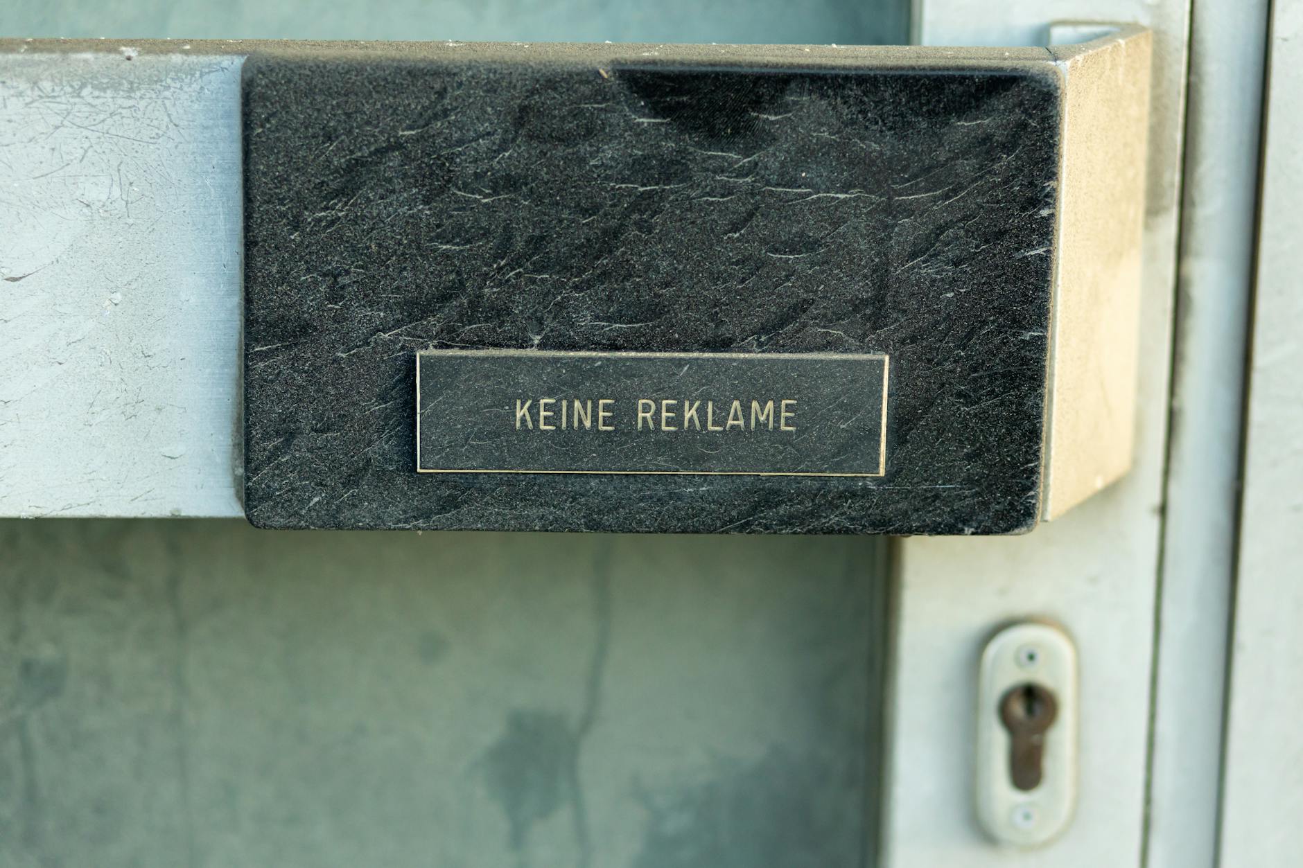 Sign reading 'Keine Reklame' on a door in Austria, no advertising.
