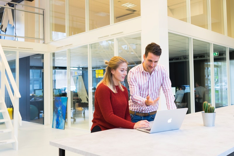 man and woman working in office