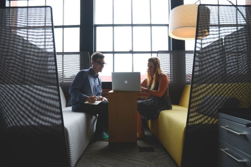 Man and woman working in an open workspace