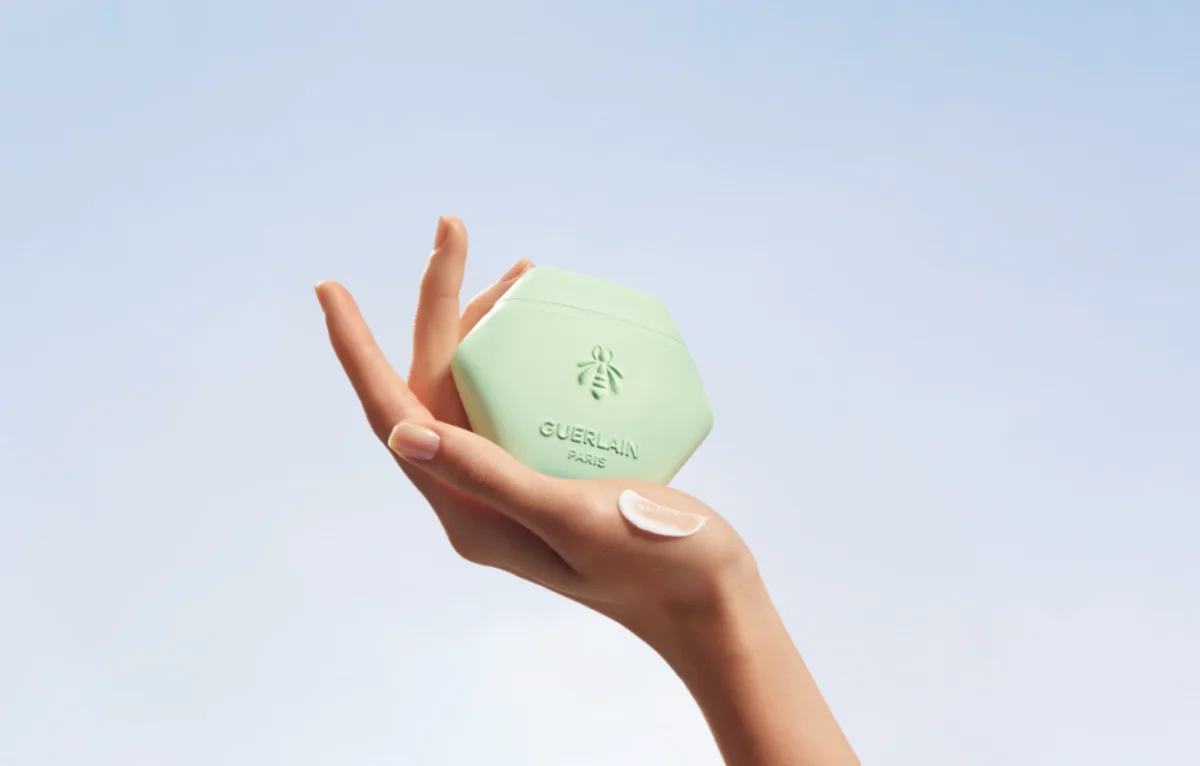 Hand holding Guerlain beauty product