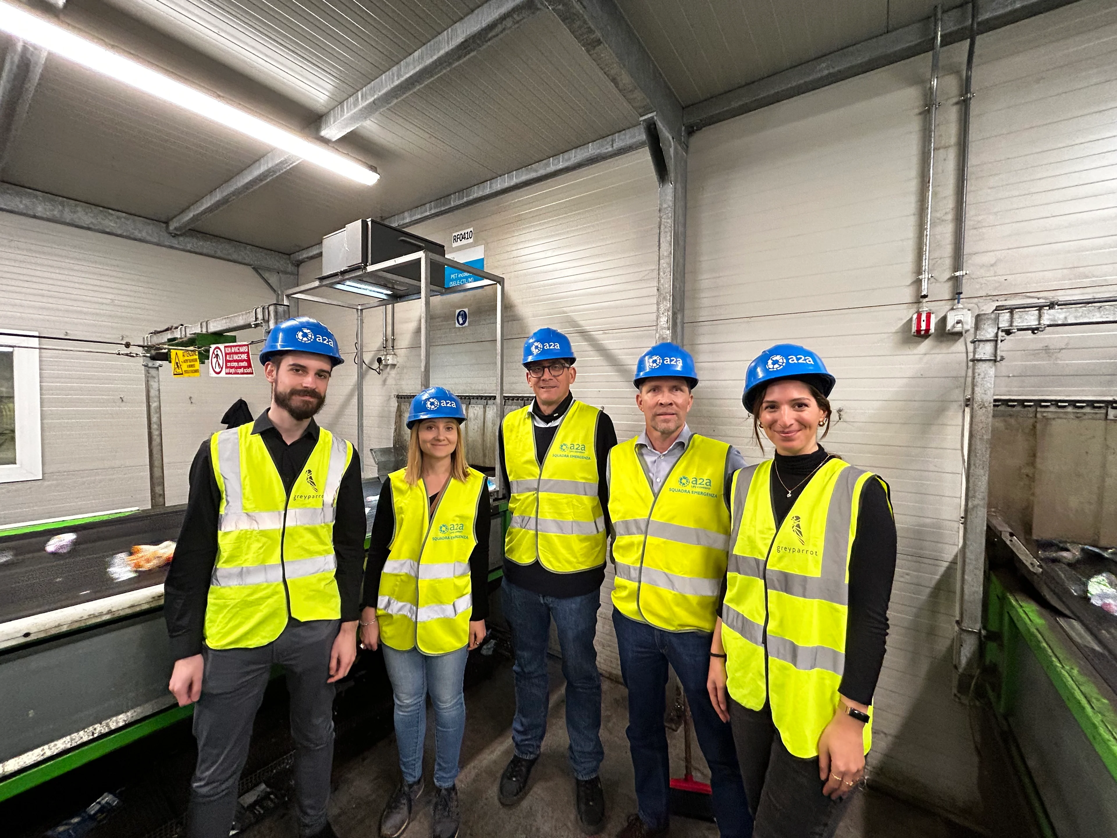 Amcor and Greyparrot representatives visit a sorting center using Greyparrot technology. 