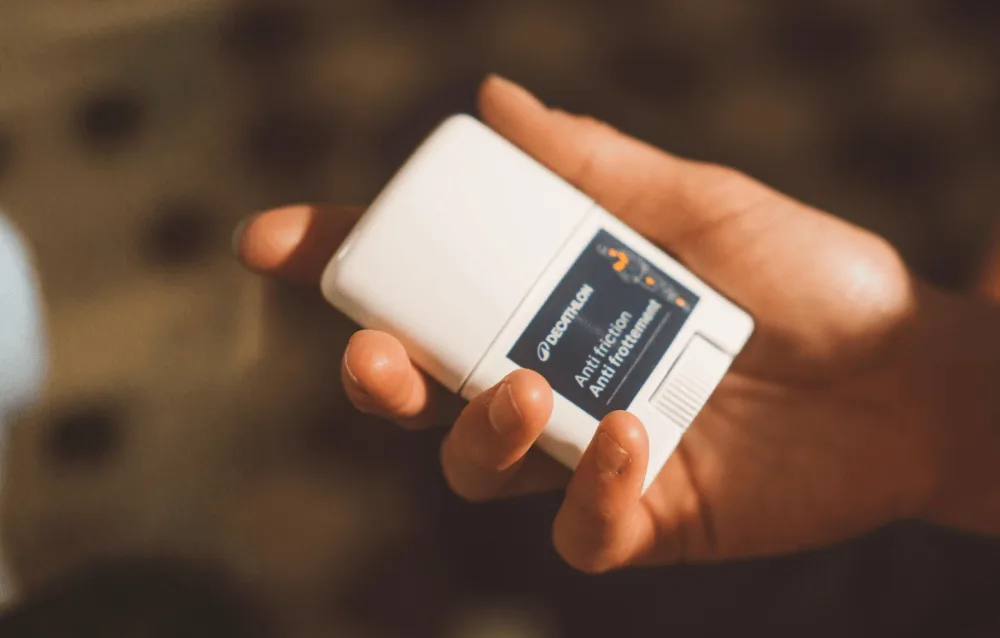 Hand holding a white anti-friction product