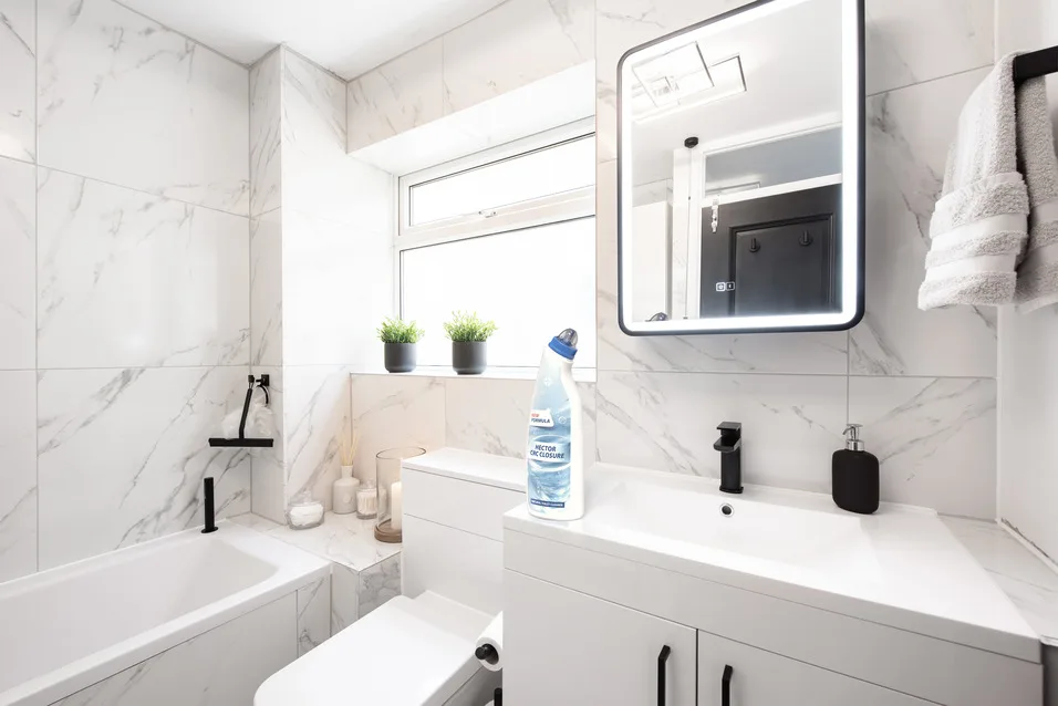 Modern marble bathroom with white fixtures