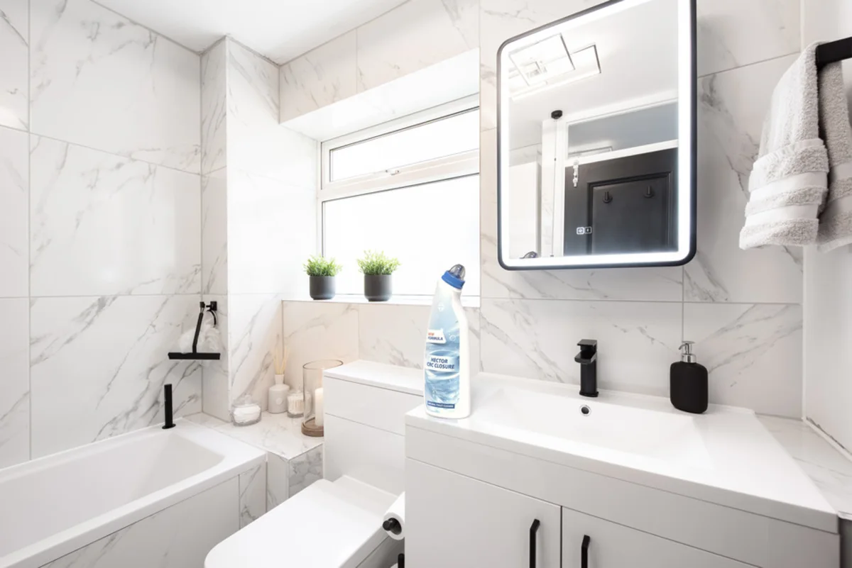 Modern marble bathroom with white fixtures