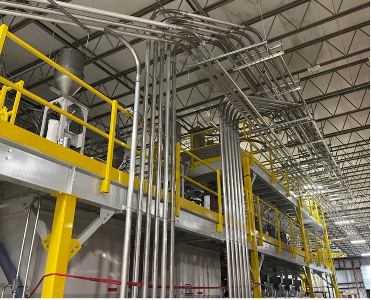 Industrial processing facility with yellow safety railings