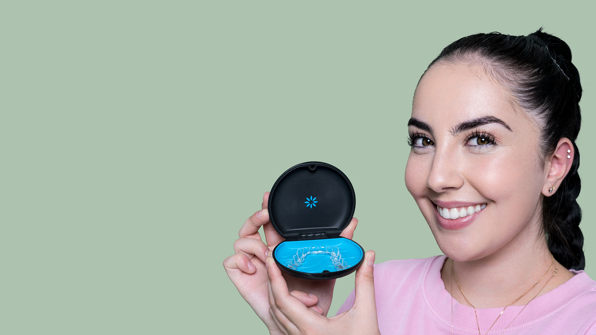 Emily with Invisalign case in hand at Vogue Dental Studios
