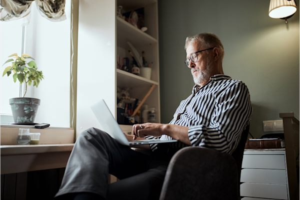 Man sitting at his desk on his laptop