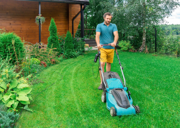 Man cutting his grass with a lawnmower