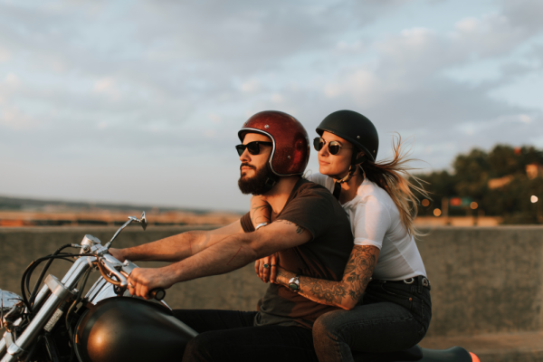 A young couple on a motorcycle together