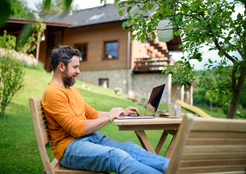 A man working on his laptop outdoors