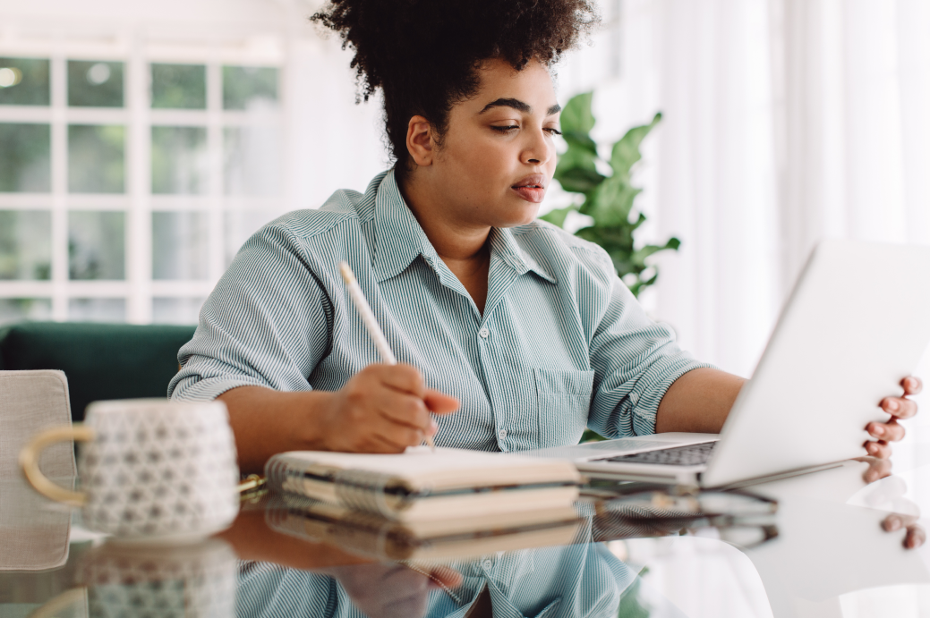 Woman working and looking down at her laptop