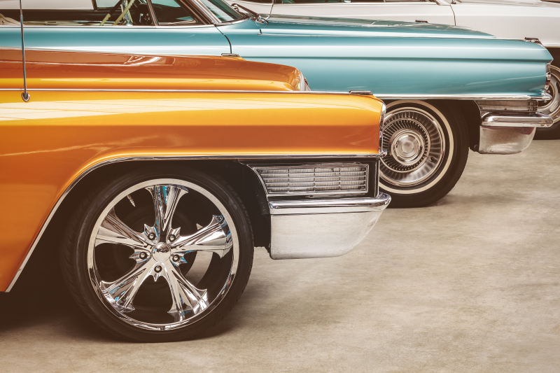 Orange and blue classic cars beside one another