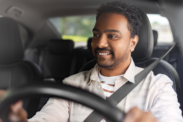 Man driving behind the wheel of a vehicle