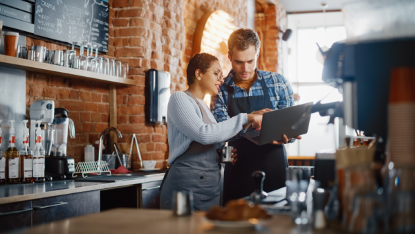 Two entrepreneurs having a team meeting in their coffee shop