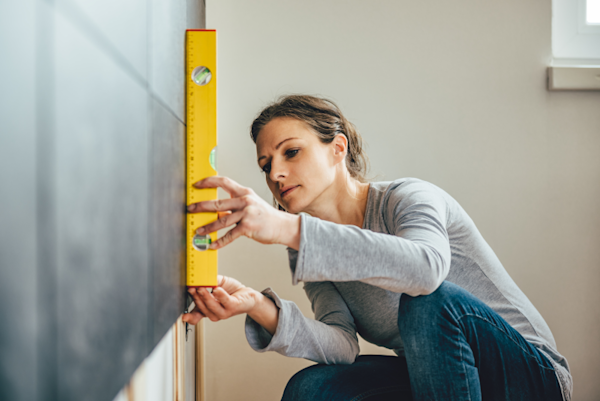 Woman using a level