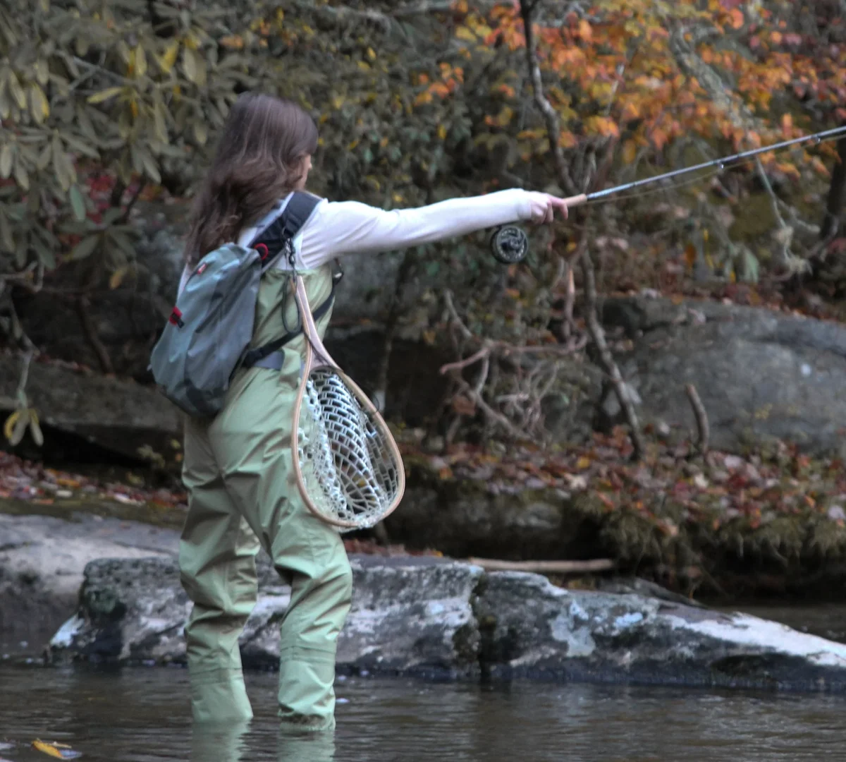 Female angler wearing Miss Mayfly Moxie Chest Waders in the stream