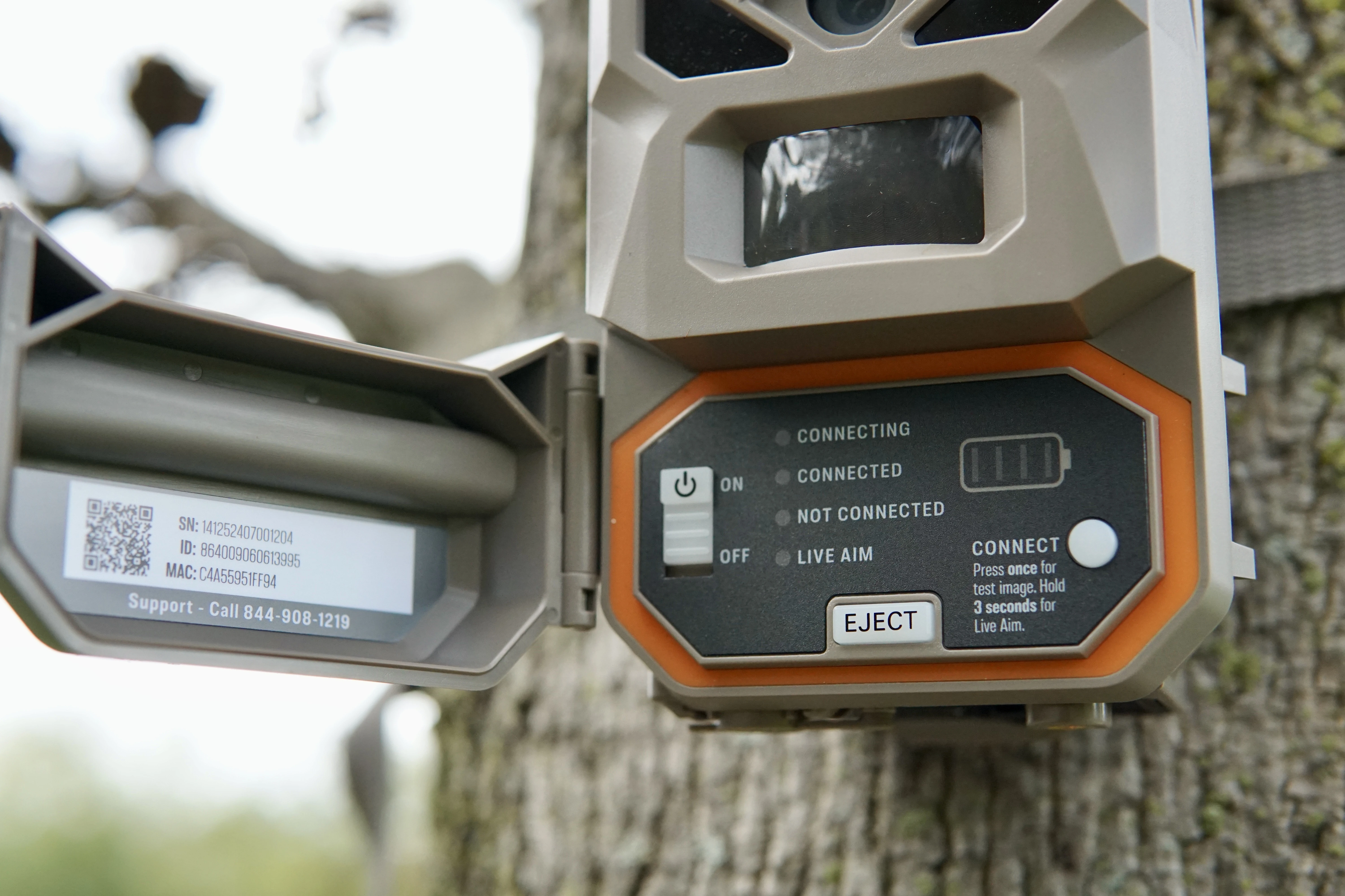 The Moultrie Mobile Edge Pro 2 cellular trail camera with door open to shot controls. 