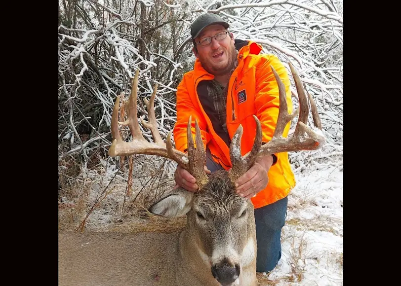 A hunter poses with a trophy whitetail taken in Montana. 