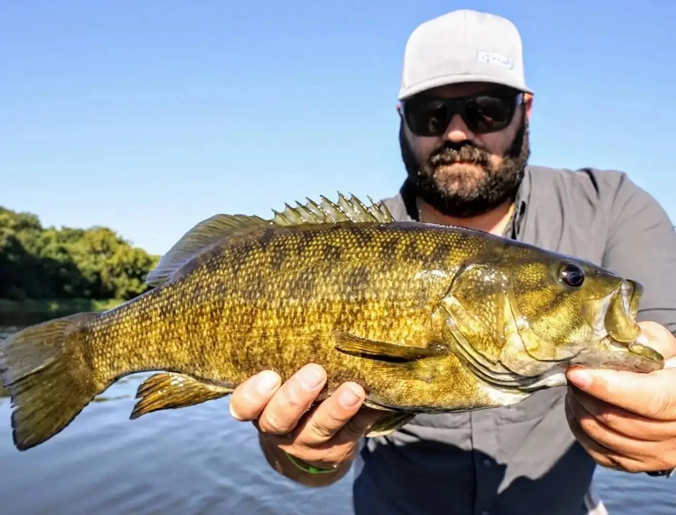 Angler holding up smallmouth bass