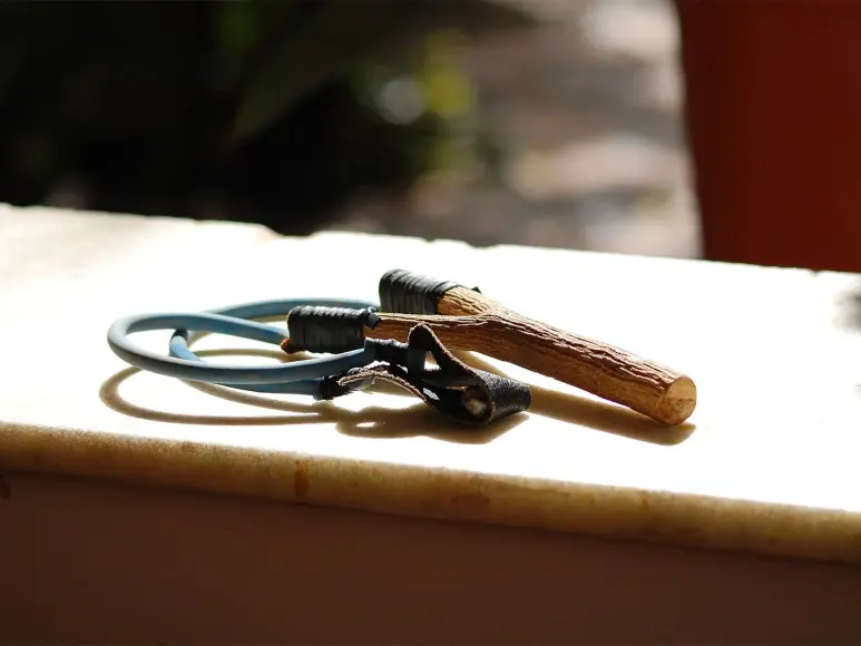 A slingshot on a windowsill in the sun.