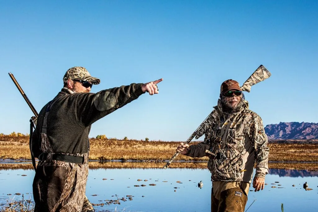 Hunters scouting a lake for ducks.