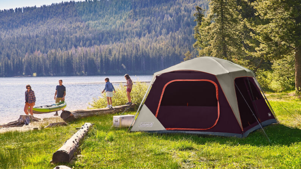 Family camping at a lake with Coleman tent