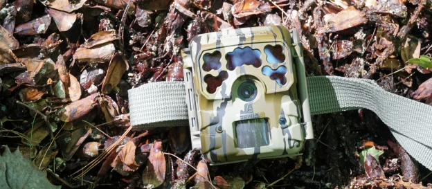 The Moultrie Micro 42i Kit trail camera lying on the ground. 