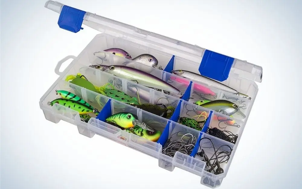 A transparent plastic box with some blue parts, which is open and inside it several different baits for catching fish.