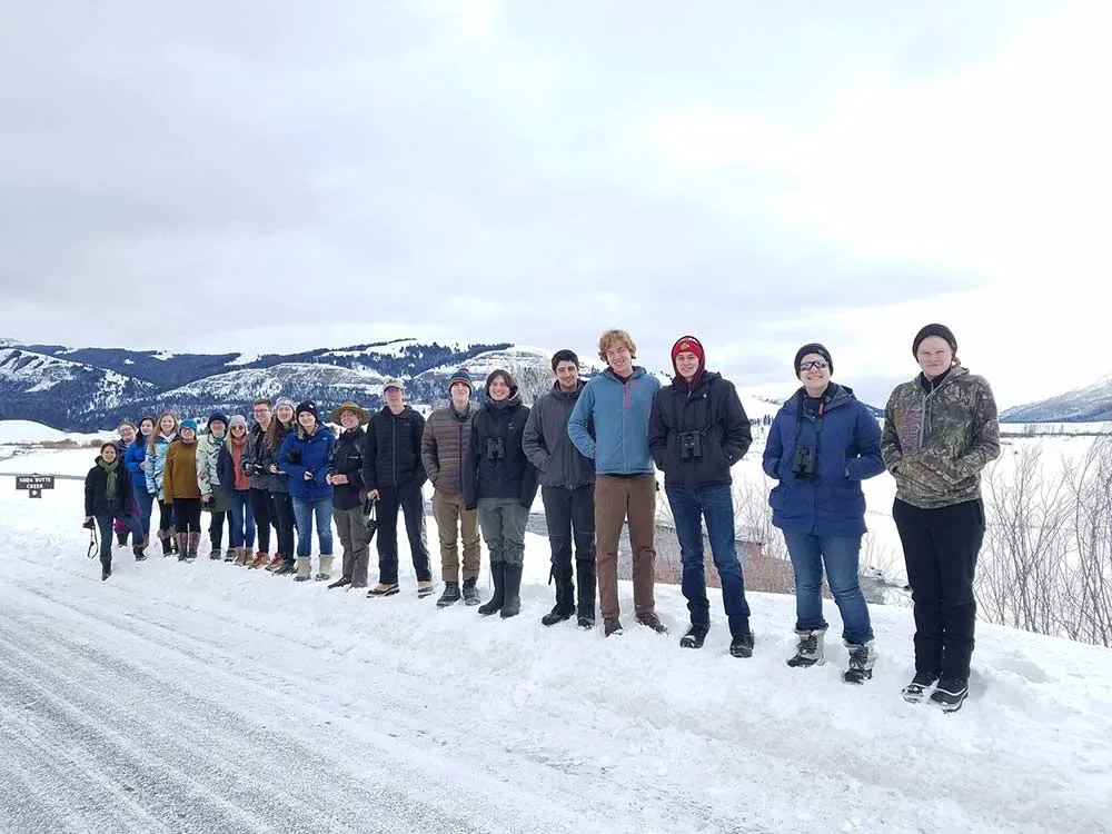 group of hunters standing in snow