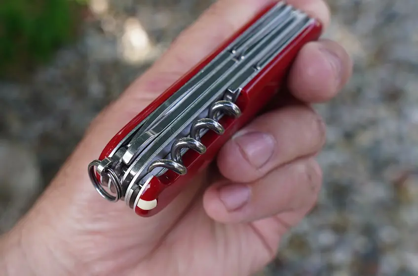 Close-up of hand holding Victorinox Huntsman multi-tool from Swiss Army