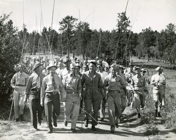 A group of WWII Air Force veterans march outside of a hospital