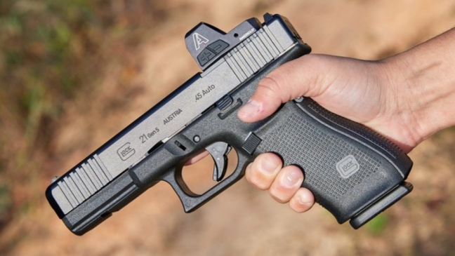 Man holding Glock pistol with AmeriGlo Glock sight