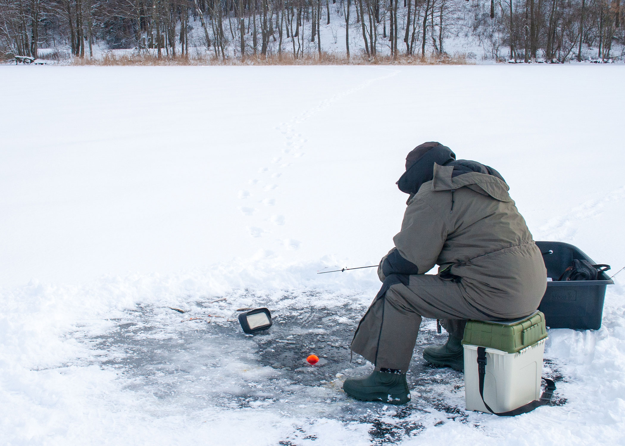An ice angler uses sonar to locate fish. 