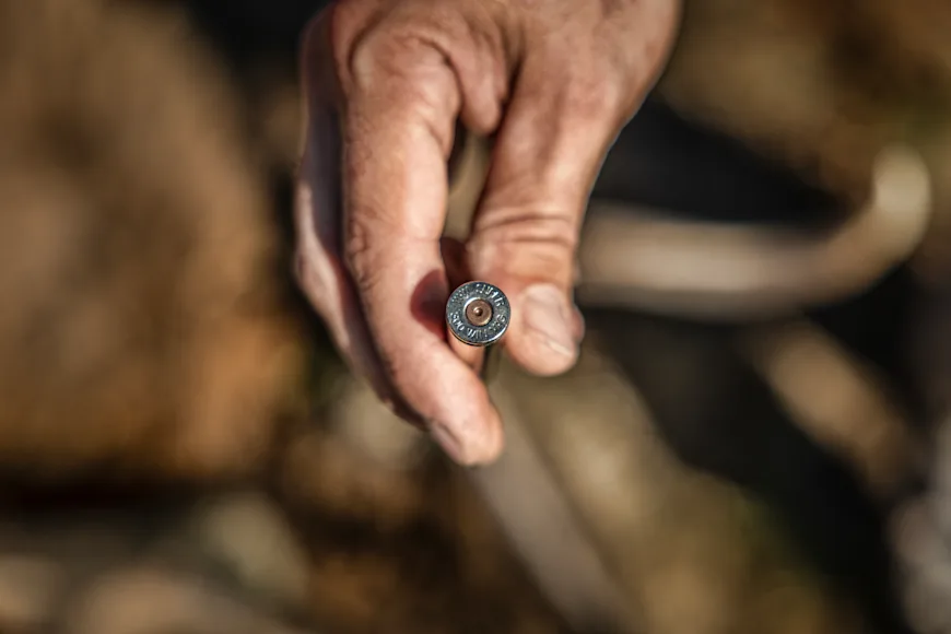 A shooter holds a 300 Win Mag cartridge.