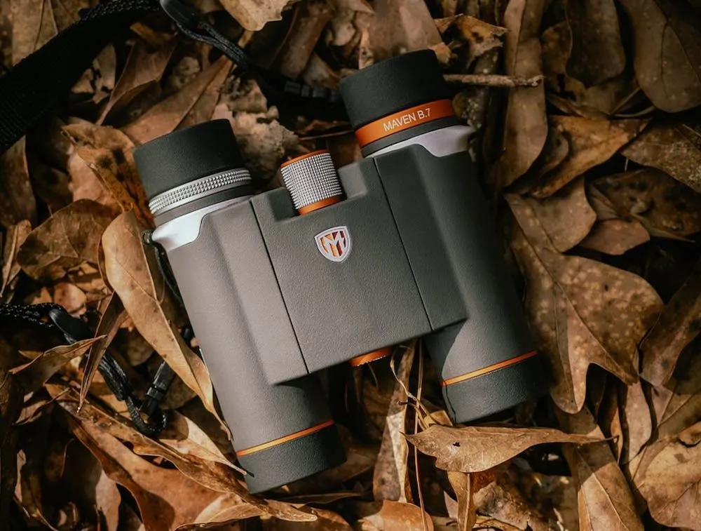 Maven binoculars sitting on leaves