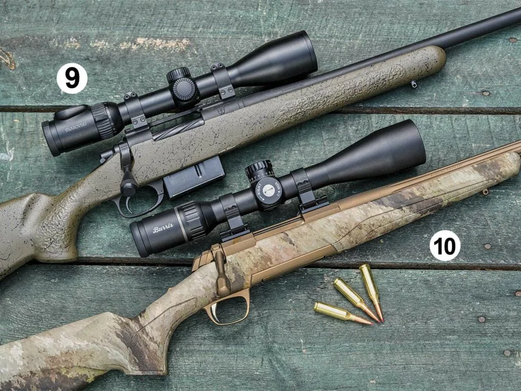 Two rifles arranged on a wooden table.